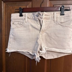 Beige distressed denim shorts